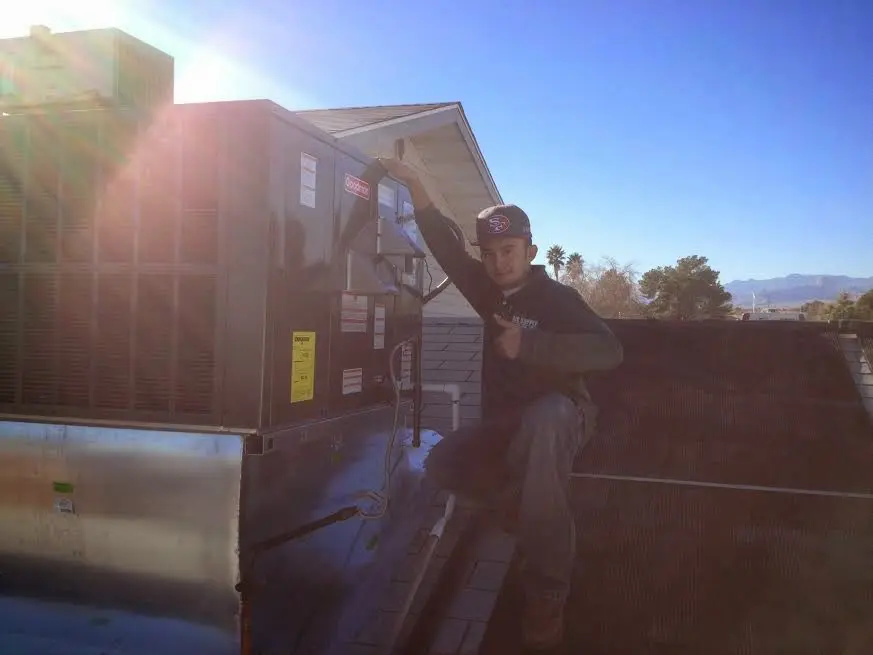 HVAC technician performing Boiler Repair on a rooftop unit in Pittsburg